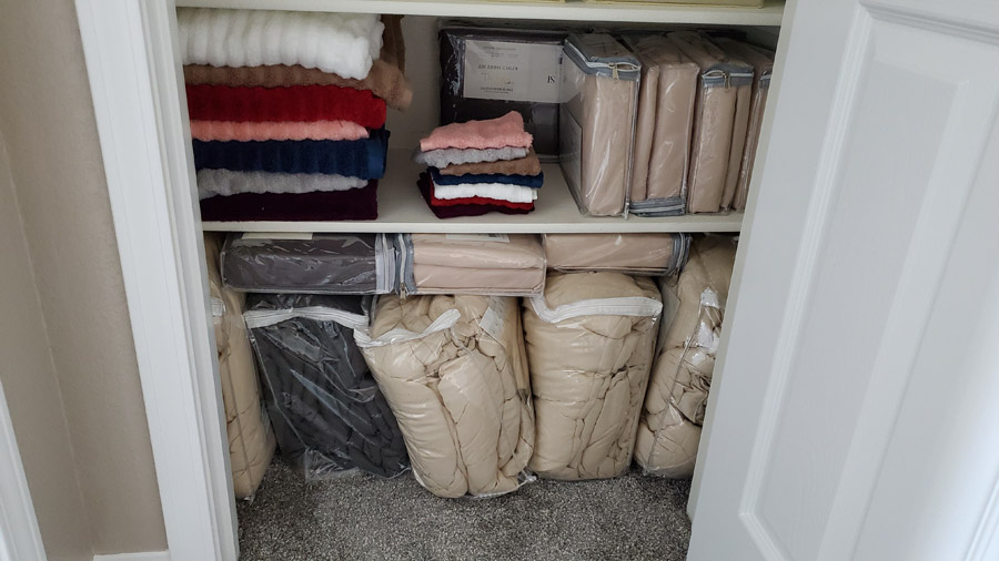 Linen Closet stocked with blankets and sheets